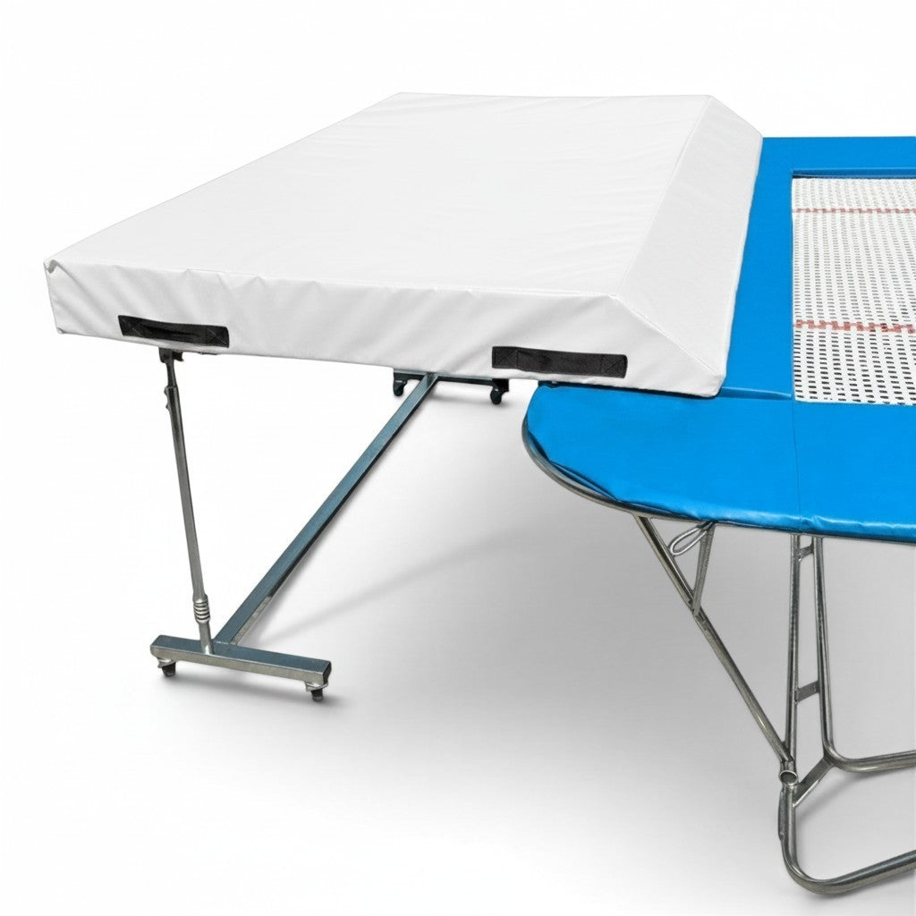 UK Gym Pits international spotting end deck with white safety mat attached to a blue trampoline frame