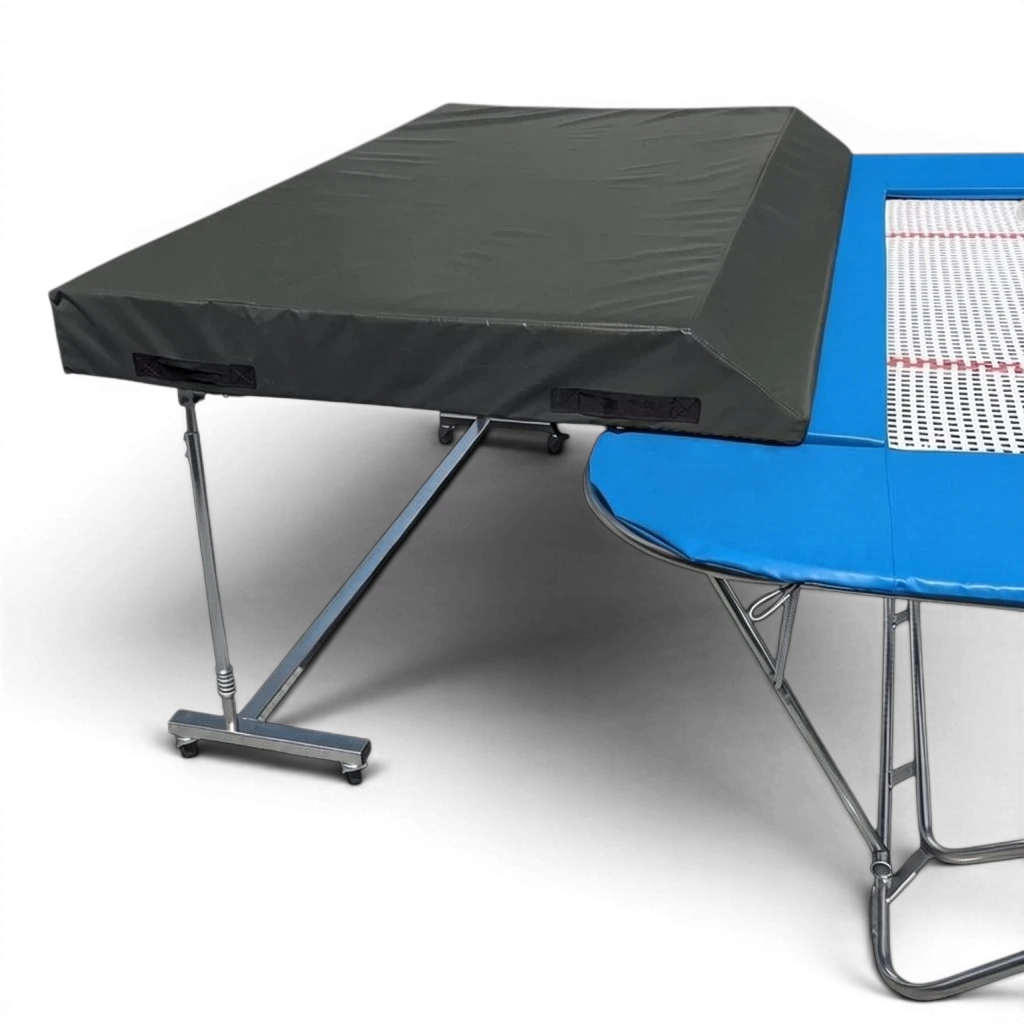 UK Gym Pits international spotting end deck with a black wedged safety mat attached to a blue trampoline frame