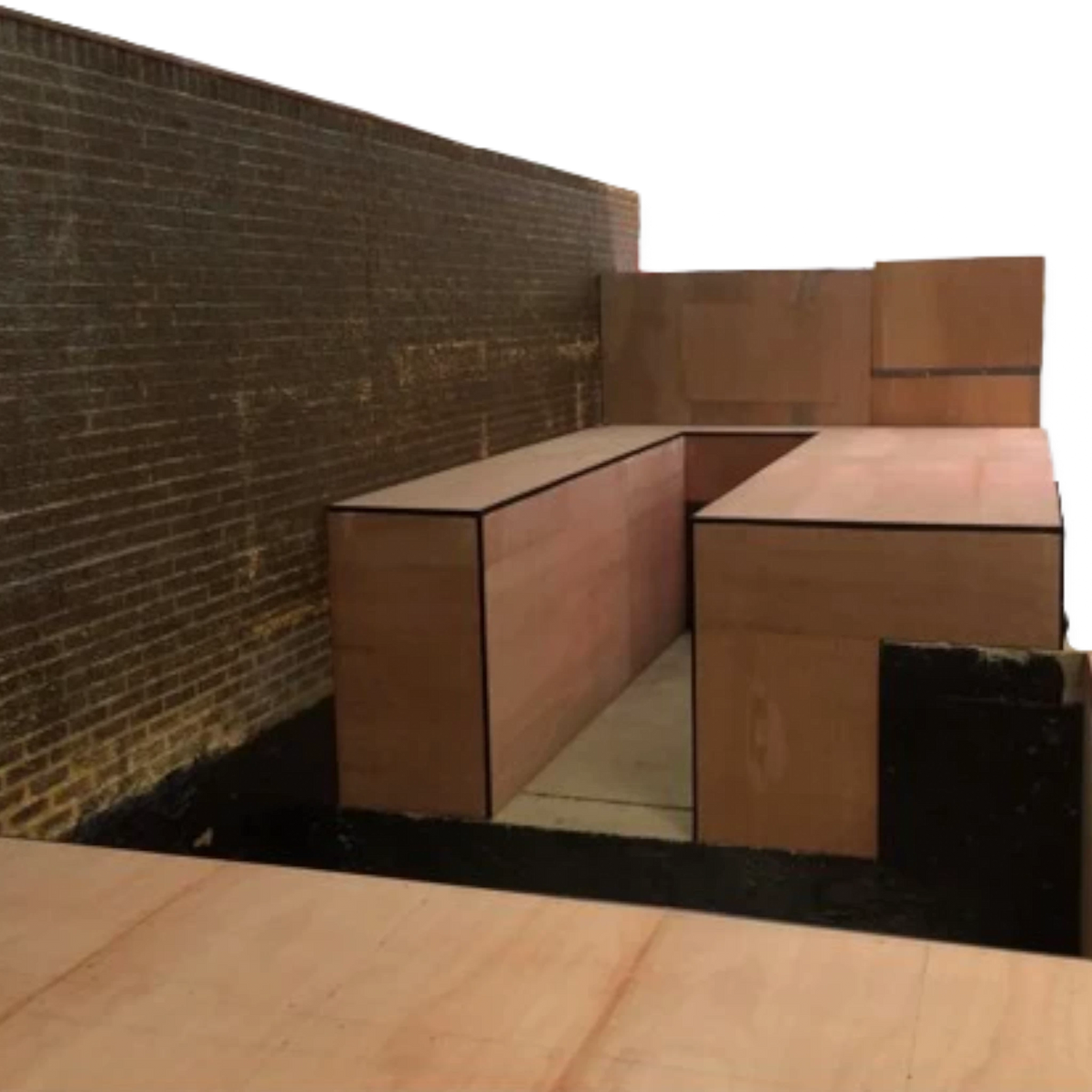 UK Gym Pits custom sunken gymnastics pit construction featuring wooden wall panels and safety padding installation