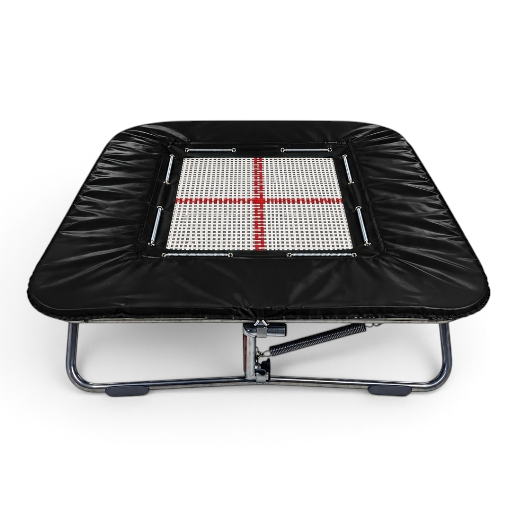 UK Gym Pits super mini trampoline with a white web bed, red cross marking, and black protective frame pads.