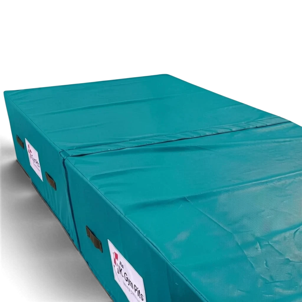 UK Gym Pits teal high-density foam track run-up block with anti-slip base and heavy-duty handles for gymnastics.