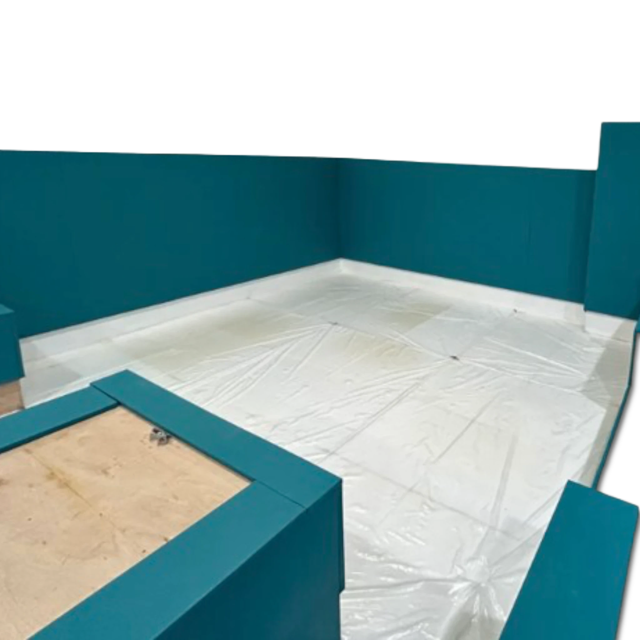 UK Gym Pits teal wall padding installed in a gym facility with a white protective floor covering