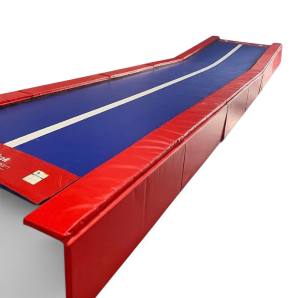 UK Gym Pits Tumbl Trak Xtreme gymnastics tumbling track with blue vinyl bed, white center line, and red side pads.