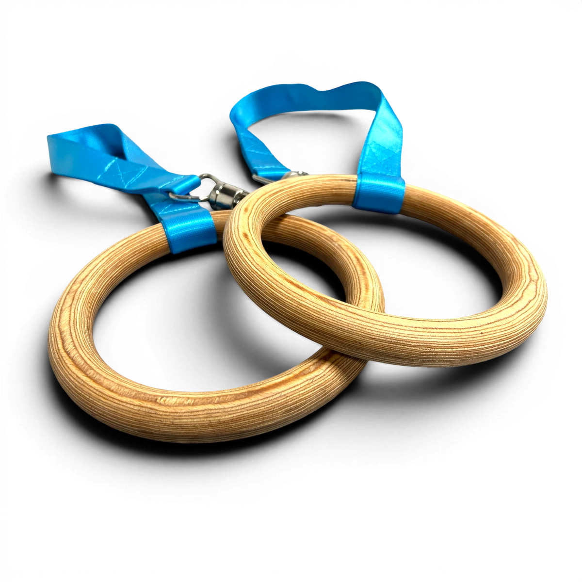 UK Gym Pits FIG approved wooden gymnastics rings with bright blue nylon straps against a black background.