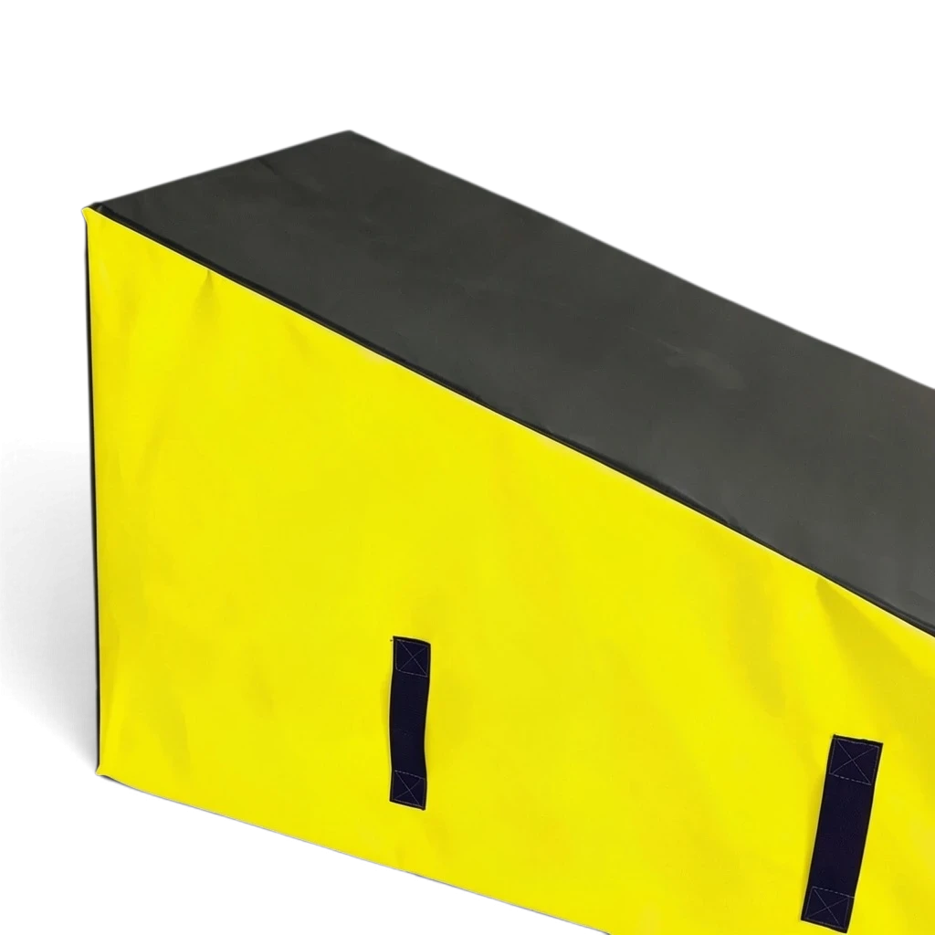 UK Gym Pits parkour wedge block with a black top and yellow sides, featuring durable PVC and carry handles.