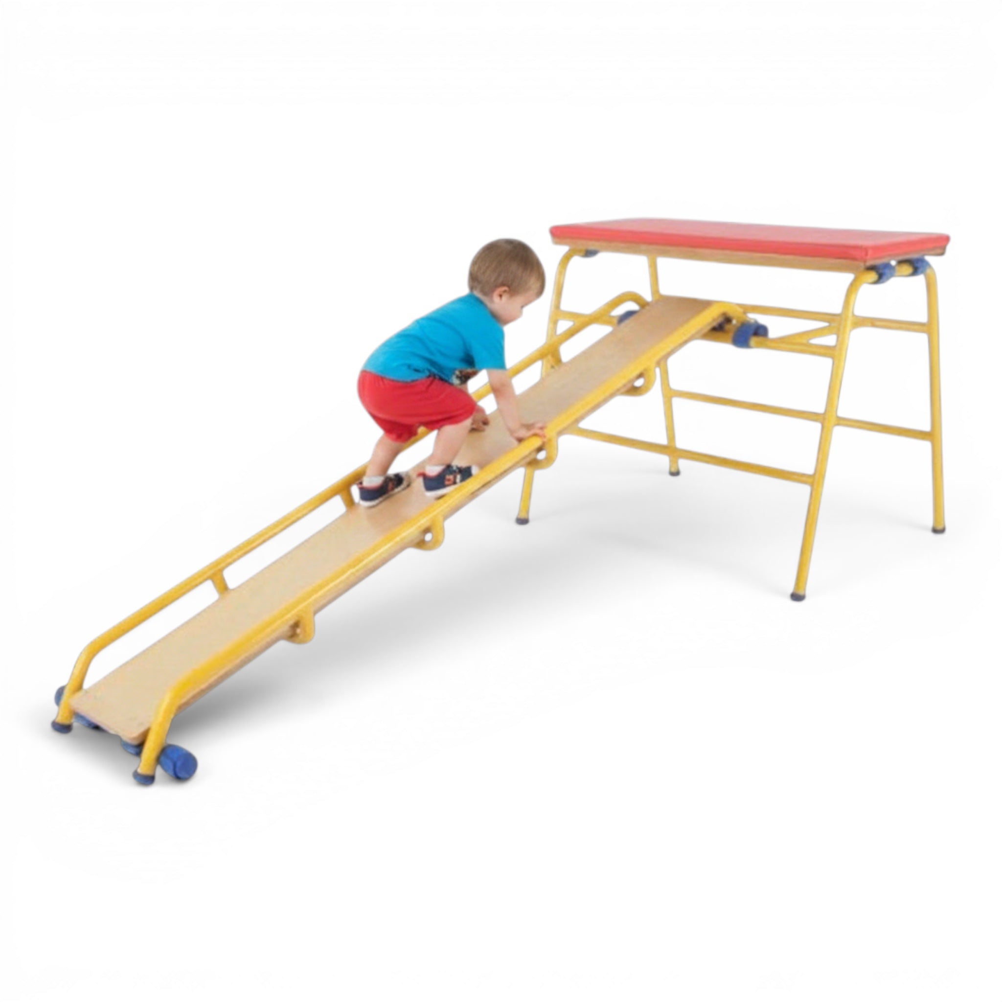 A young child climbing a yellow UK Gym Pits metal ladder attached to a trestle in a gymnastics setting.