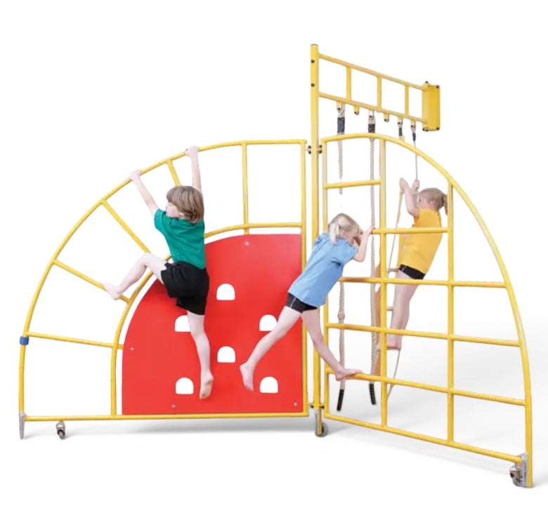 Children climbing on a yellow UK Gym Pits steel climbing frame with a red panel and ladder in a school gym setting